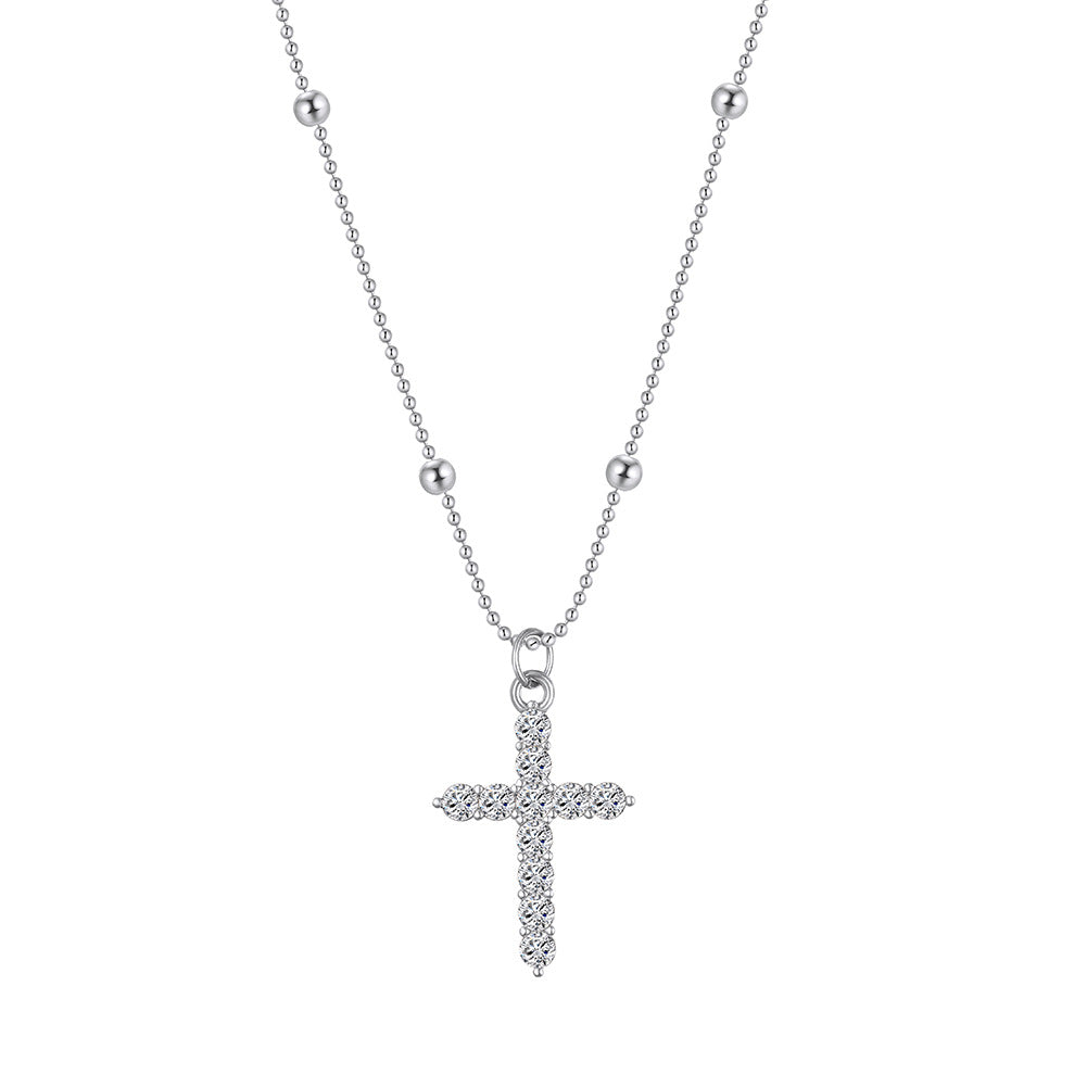 The cross-shaped pendant is set with a high-end and versatile look in yellow