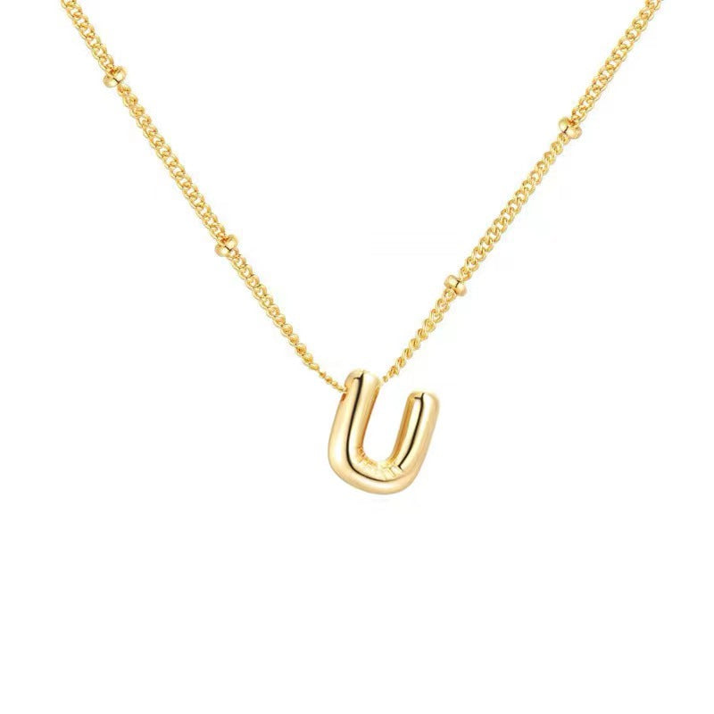 The letter pendant is available in 26 colors in 18K