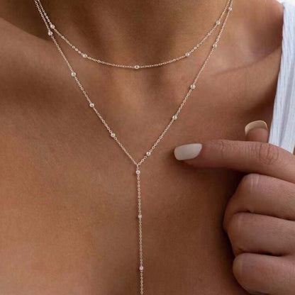 The multi-layered and stackable long pendant is a chain with tassels