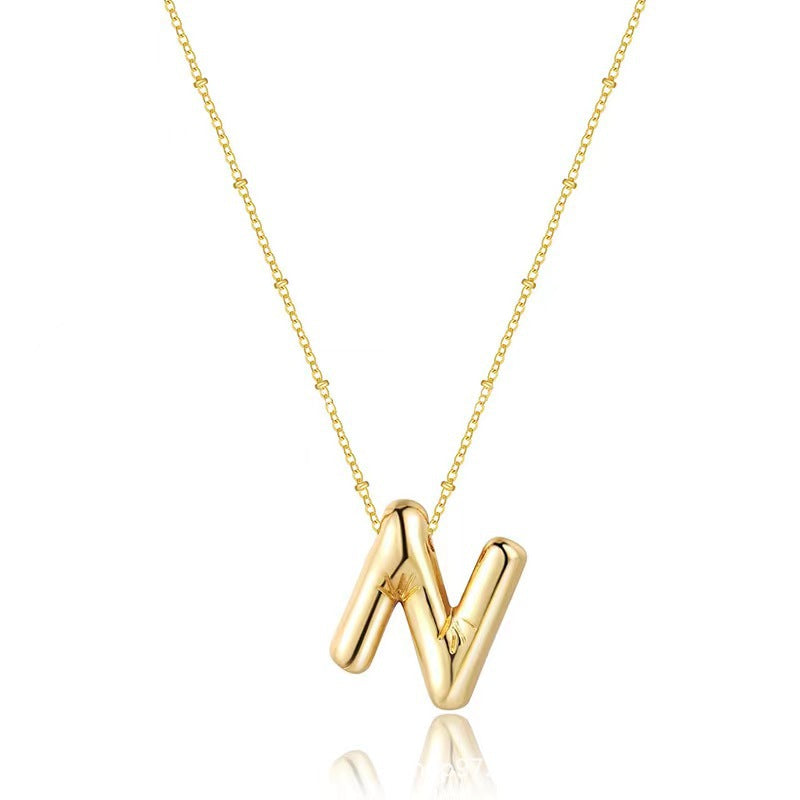 The letter pendant is available in 26 colors in 18K
