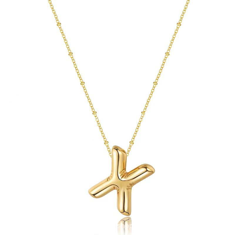 The letter pendant is available in 26 colors in 18K