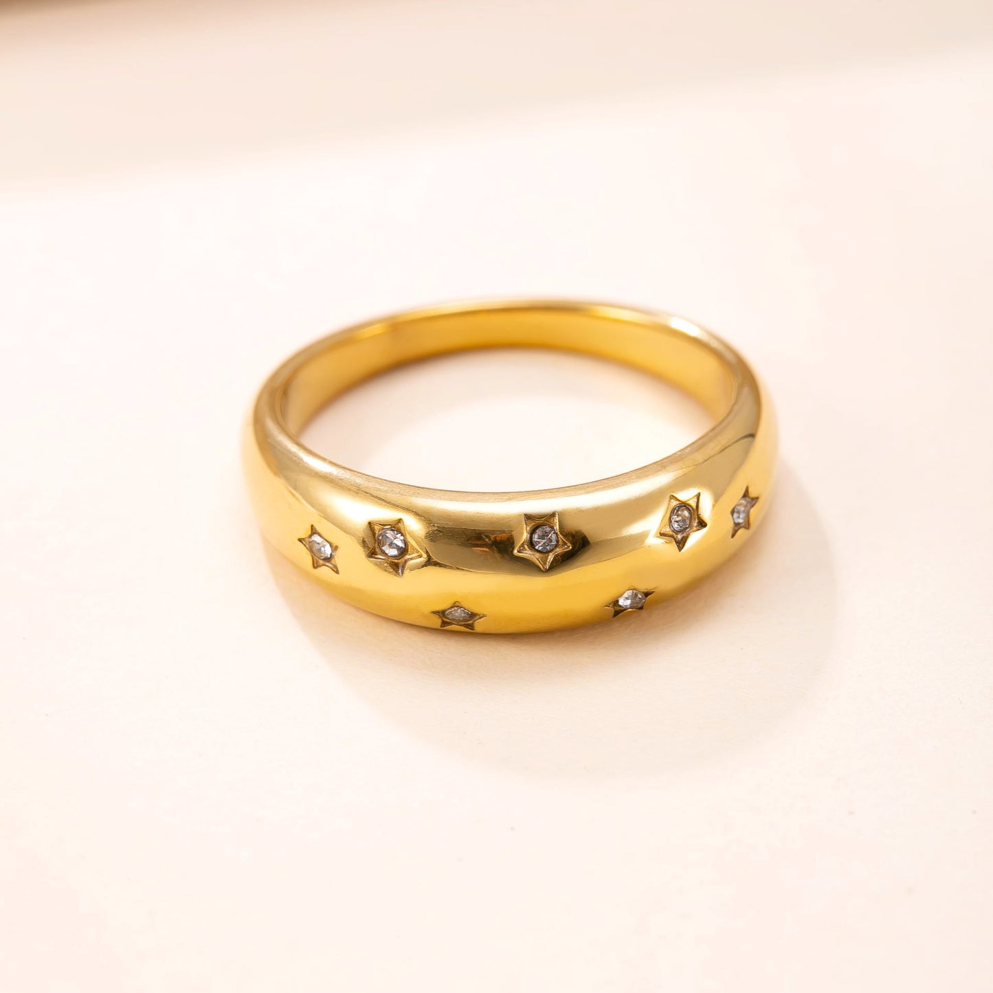 A trendy 18k cast star-studded ring for women