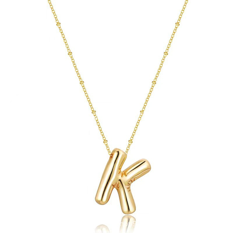 The letter pendant is available in 26 colors in 18K