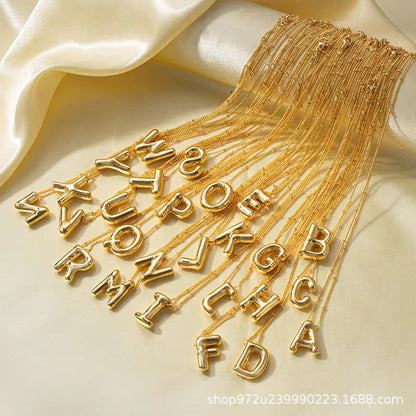 The letter pendant is available in 26 colors in 18K