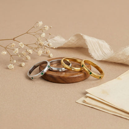 A white and green bezel ring with a silver dual-color commuting layering style