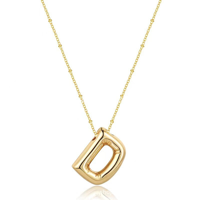 The letter pendant is available in 26 colors in 18K