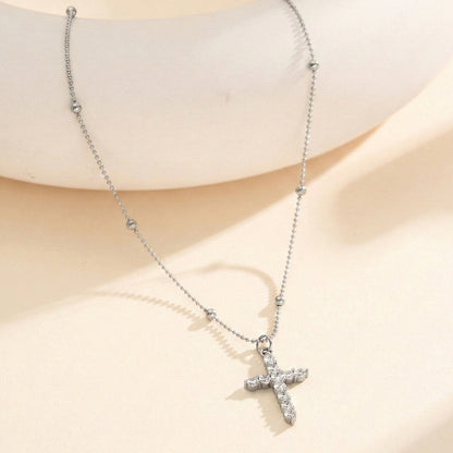 The cross-shaped pendant is set with a high-end and versatile look in yellow