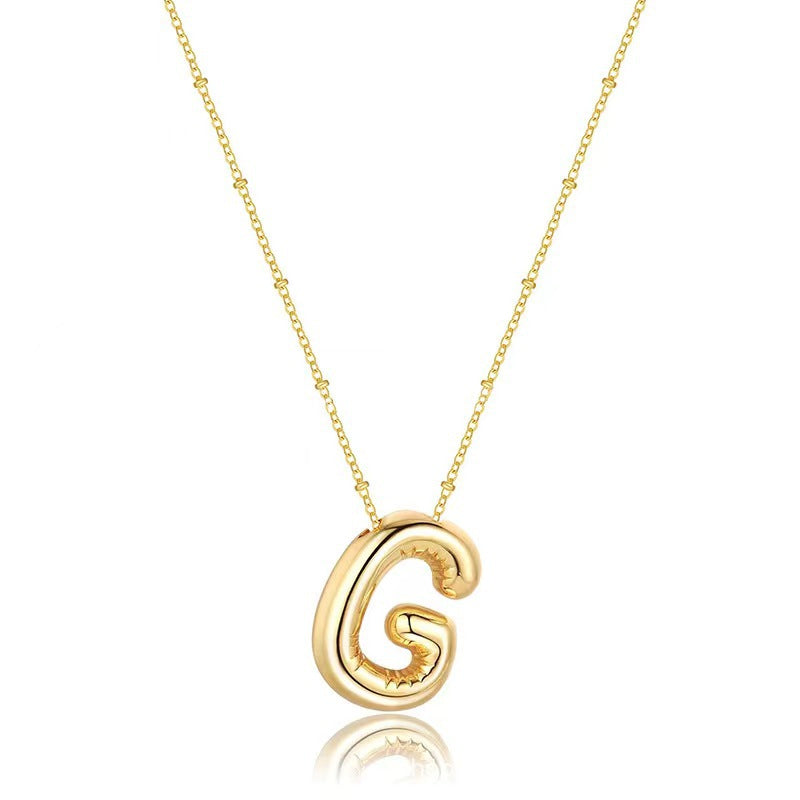 The letter pendant is available in 26 colors in 18K