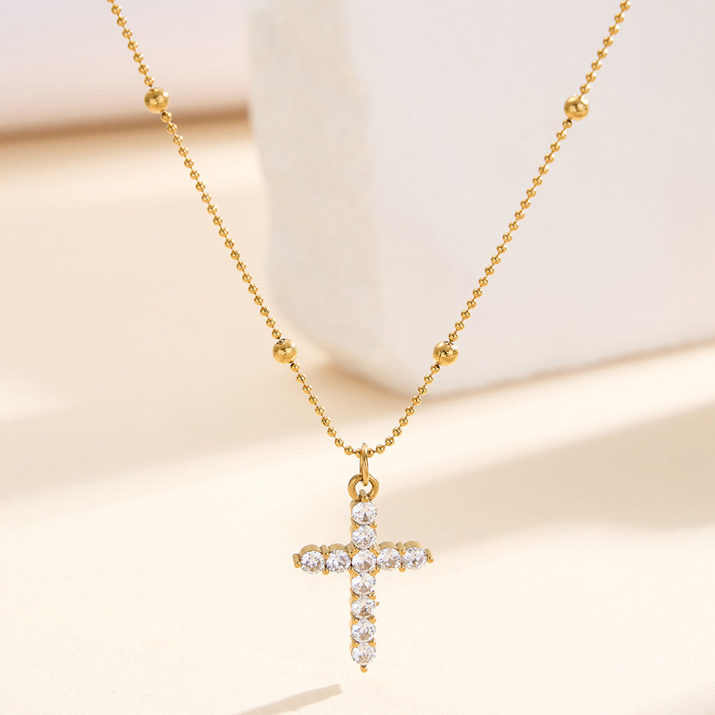 The cross-shaped pendant is set with a high-end and versatile look in yellow